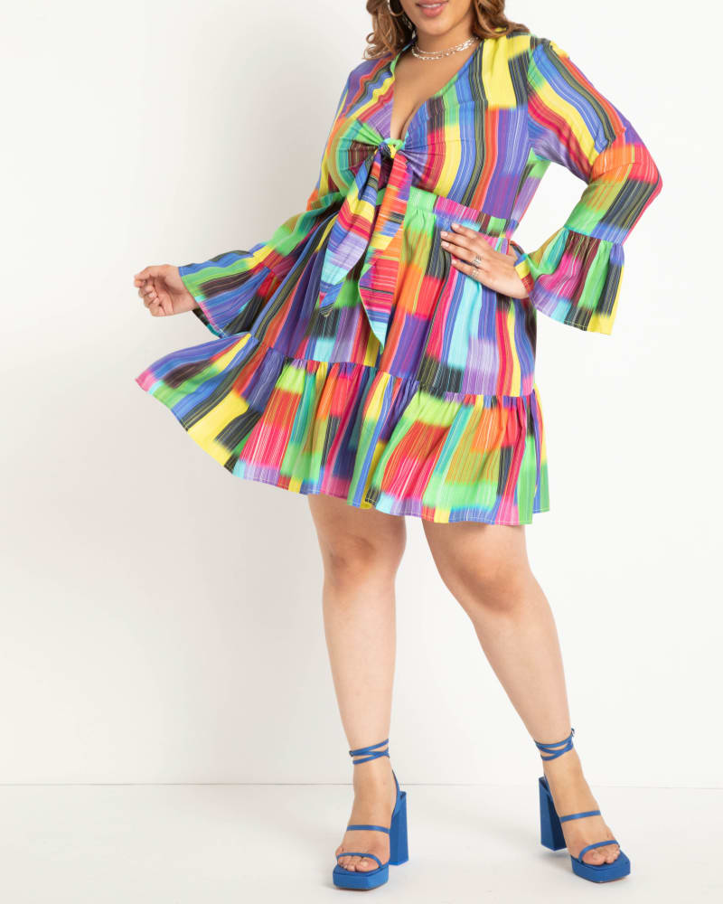 Front of a model wearing a size 14 Tie Front Mini Dress in Psychadelic Blocks by ELOQUII. | dia_product_style_image_id:290146